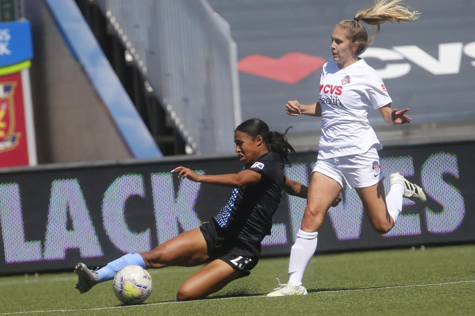 Sky Blue's Midge Purce (23) kicks the ball as Washington Spirit's Ashley Sanchez, right, defends during the first half of an NWSL Challenge Cup soccer match at Zions Bank Stadium Saturday, July 18, 2020, in Herriman, Utah. (AP Photo/Rick Bowmer)