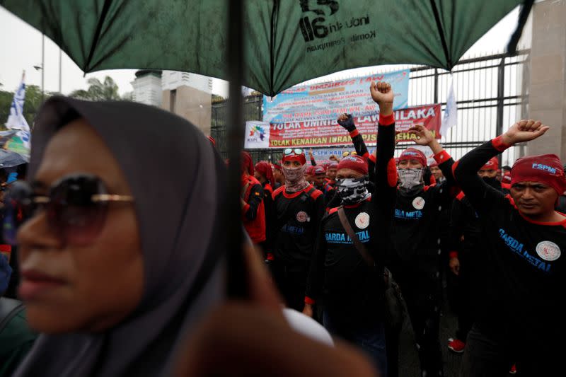 Labourers shout slogans as they take part in a protest outside Indonesia's parliament building in Jakarta