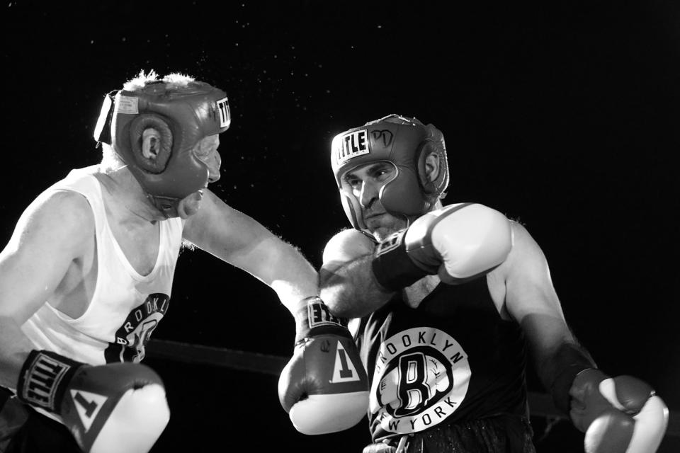 <p>Sgt. Billy Gattis gets clobbered with a punch thrown by Sgt. Russell Rodin in a battle of property clerks at the Brooklyn Smoker on Aug. 24, 2017. Gattis won the bout in a split decision. (Photo: Gordon Donovan/Yahoo News) </p>