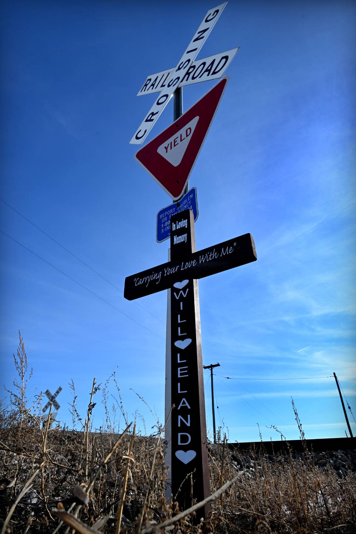 A cross with the names of two men who died when their vehicles were struck by Norfolk Southern freight trains has been placed at the crossing near Salisbury, Missouri.