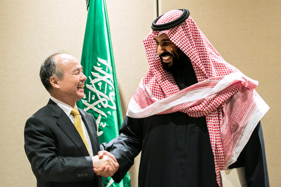 Son, left, shakes hands with Mohammed bin Salman, Saudi Arabia’s crown prince, after signing an agreement in New York, U.S., on Tuesday, March 27, 2018. (Jeenah Moon/Bloomberg via Getty Images)