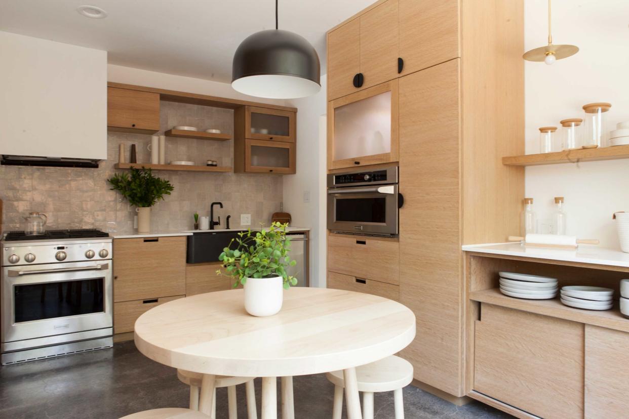  a small kitchen with a table in the center 