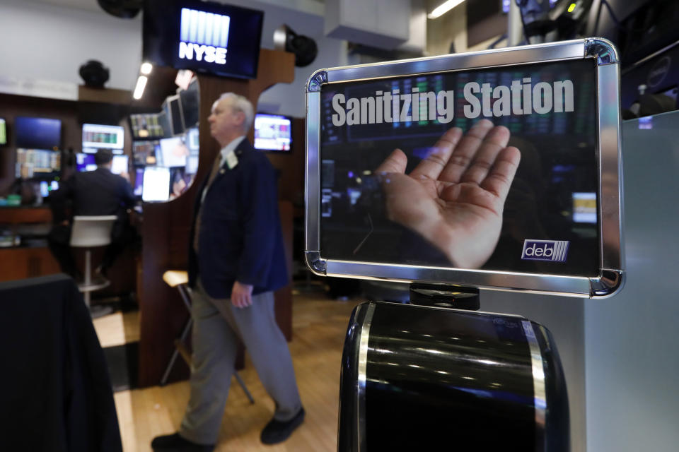 A trader passes a hand sanitizing station on the floor of the New York Stock Exchange, Tuesday, March 3, 2020. Federal Reserve Chairman Jerome Powell noted that the coronavirus "poses evolving risks to economic activity." (AP Photo/Richard Drew)