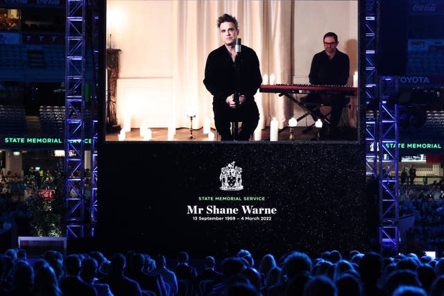 Musician Robbie Williams performs a tribute by video