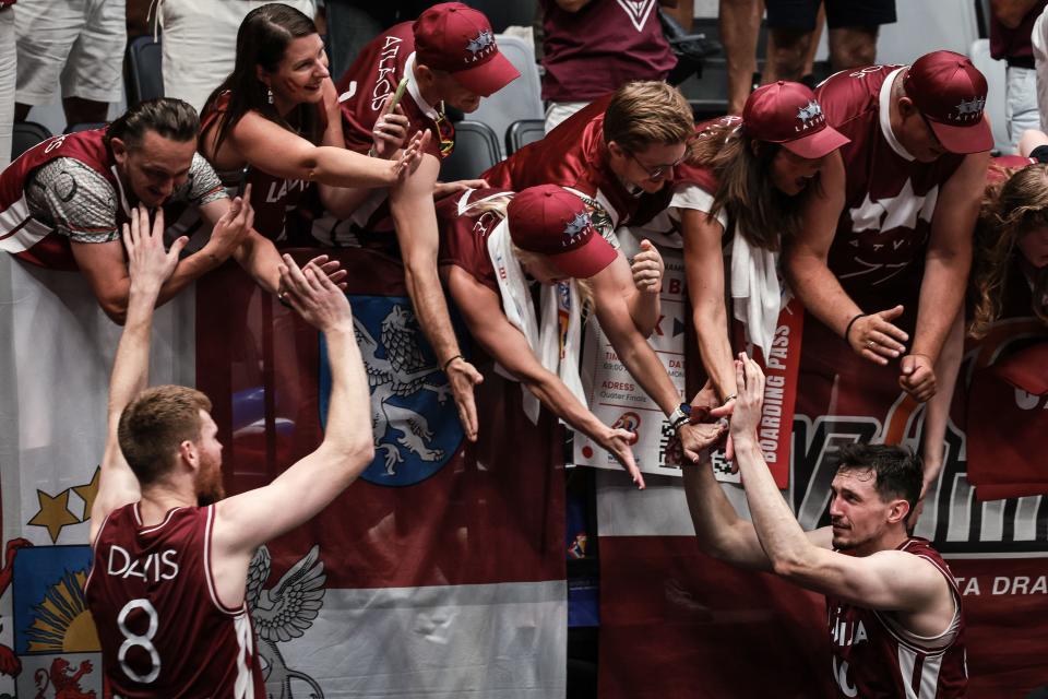 Latvia’s Rodions Kurucs (R) and Davis Bertans (L) celebrate with supporters after winning the FIBA Basketball World Cup group L match between Brazil and Latvia at Indonesia Arena in Jakarta on September 3, 2023. (Photo by Yasuyoshi CHIBA / AFP) (Photo by YASUYOSHI CHIBA/AFP via Getty Images)