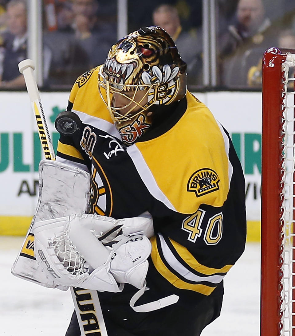 Boston Bruins goalie Tuukka Rask makes a save against the Detroit Red Wings during the first period of Game 2 of a first-round NHL hockey playoff series in Boston Sunday, April 20, 2014. (AP Photo/Winslow Townson)