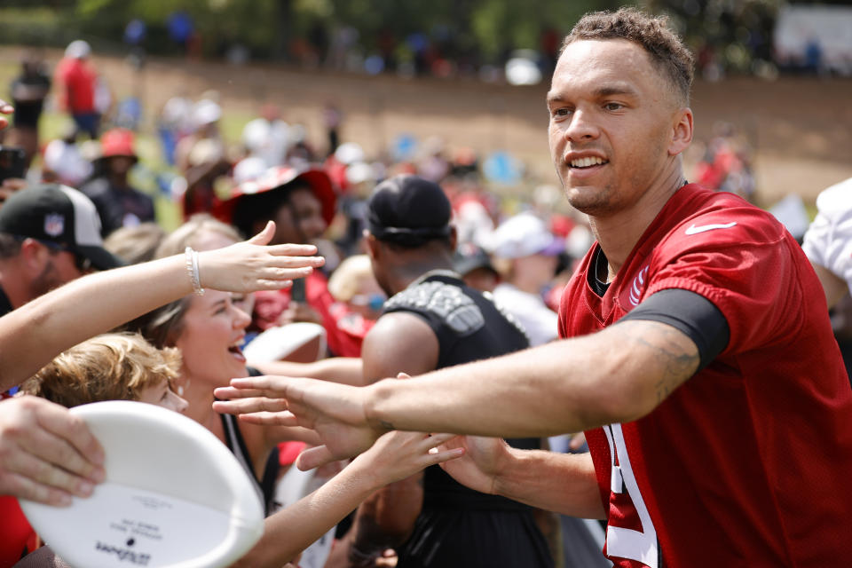 Atlanta Falcons quarterback Desmond Ridder (9) greets fans during the NFL football team's training camp, Saturday, July 29, 2023, in Flowery Branch, Ga. (AP Photo/Alex Slitz)