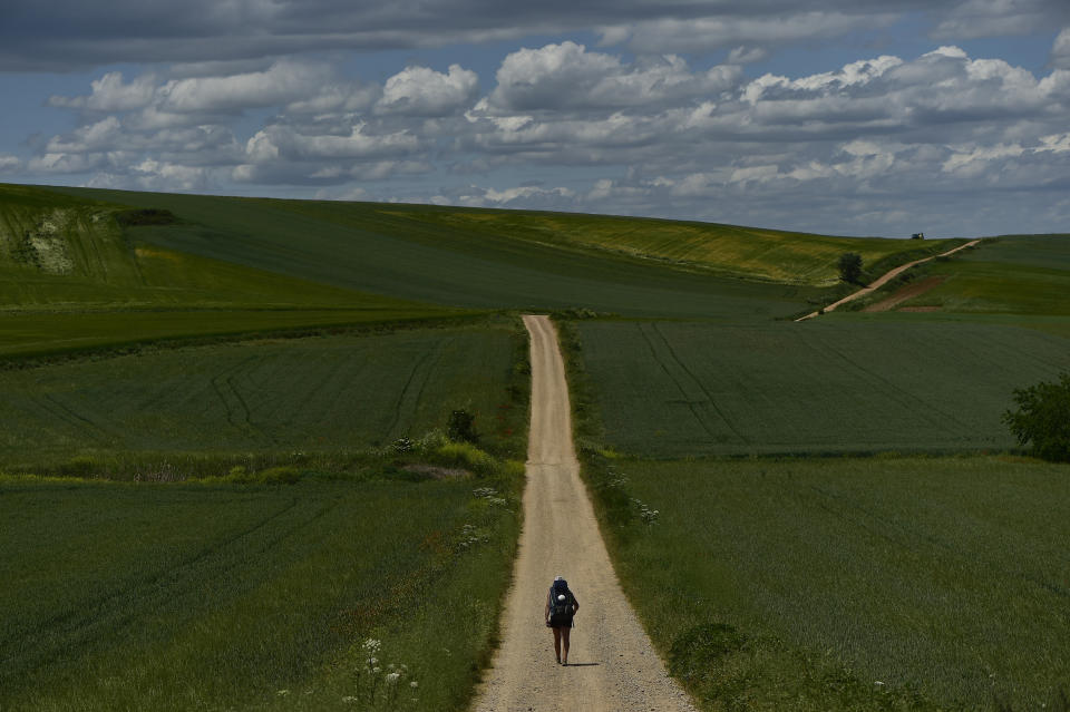 FILE - A pilgrim walks during a stage of "Camino de Santiago" or St. James Way near to Santo Domingo de La Calzada, northern Spain, May 31, 2022. In 2023, nearly half a million people walked the Camino de Santiago in Spain. About 40% did so for purely religious reasons. While it’s traditionally a Catholic pilgrimage, people today embark on the Camino for many motivations beyond religion: health, grief, transition, adventure. (AP Photo/Alvaro Barrientos, File)