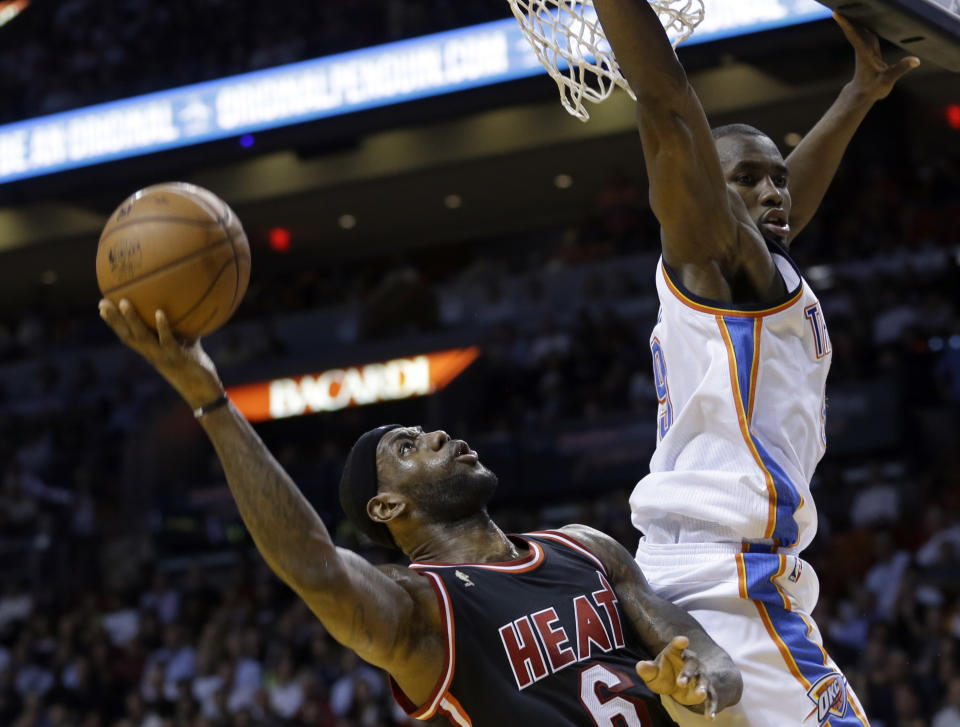 Miami Heat small forward LeBron James (6) shoots against Oklahoma City Thunder power forward Serge Ibaka (9) during the second period of an NBA basketball game in Miami, Wednesday, Jan. 29, 2014. (AP Photo/Alan Diaz)