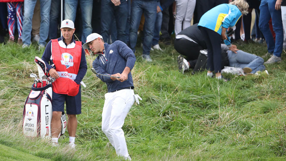 Brooks Koepka plays his second shot after his tee shot struck a spectator. (Photo by Christian Petersen/Getty Images)