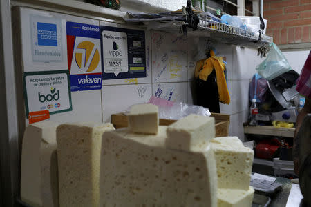 Information for Vippo app and other methods of payment is seen at a cheese and dairy products stall at Chacao Municipal Market in Caracas, Venezuela January 19, 2018. Picture taken January 19, 2018. REUTERS/Marco Bello