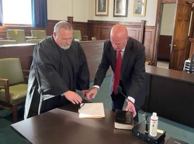 Rod Honeycutt is sworn in as county manager by Superior Court Judge Ted McEntire Feb. 21 in a ceremony at the Madison County Courthouse in Marshall.