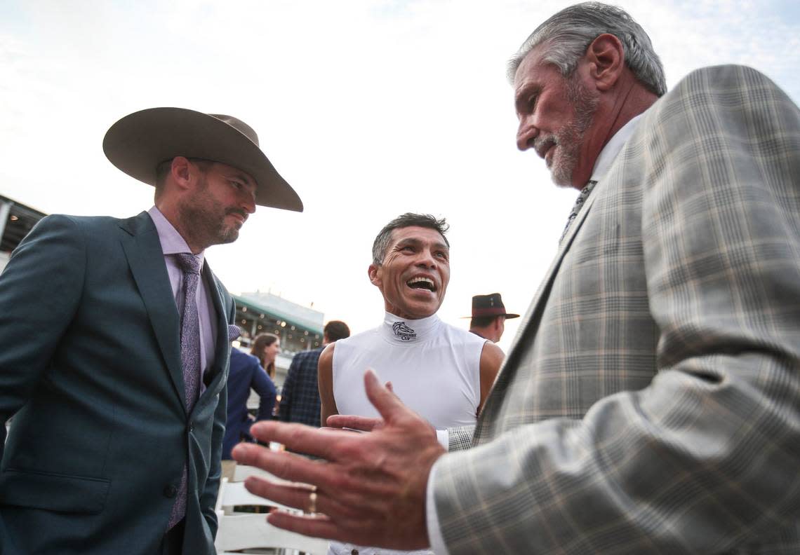 Jockey Jesus Castanon talks with owner Harry Veruchi, right, and son Vinny Veruchi after their horse, West Saratoga, drew the No. 13 position for the Kentucky Derby.