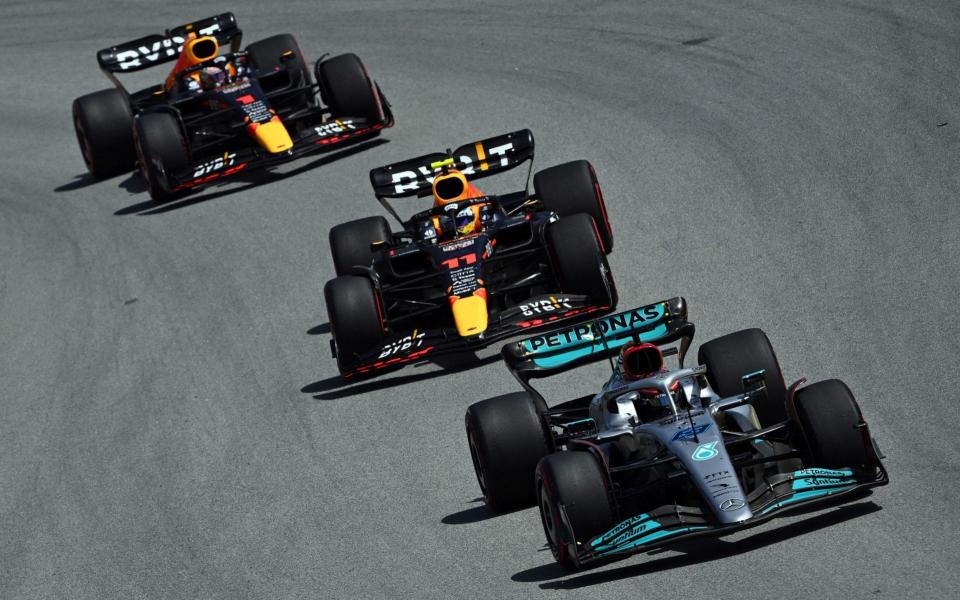 Red Bull's Dutch driver Max Verstappen, Red Bull's Mexican driver Sergio Perez and Mercedes' British driver George Russell compete during the Spanish Formula One Grand Prix at the Circuit de Catalunya on May 21, 2022 in Montmelo, on the outskirts of Barcelona. - GABRIEL BOUYS/AFP via Getty Images