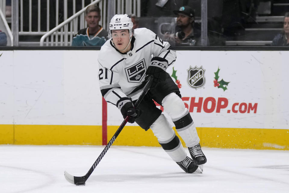 Los Angeles Kings defenseman Jordan Spence (21) skates with the puck against the San Jose Sharks during the first period of an NHL hockey game in San Jose, Calif., Tuesday, Dec. 19, 2023. (AP Photo/Jeff Chiu)