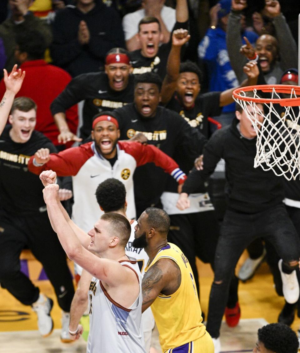 Denver center Nikola Jokic, left, celebrates after the Nuggets' victory over the Lakers.