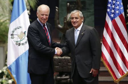 U.S. Vice-President Joe Biden and Guatemala's President Otto Perez Molina shake hands during a photo opportunity at the Presidential Palace in Guatemala City June 20, 2014. REUTERS/Pakal Koban