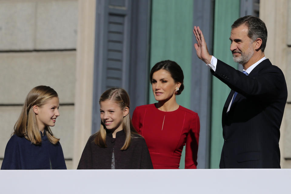Spain's King Felipe VI and his wife Queen Letizia wave to the crowd with their daughters Princess Leonor, left, and Princess Sofia after their arrival for celebrations of the 40th anniversary of the Spanish Constitution at the Spanish parliament, in Madrid, Spain, on Thursday, Dec. 6, 2018. (AP Photo/Andrea Comas)