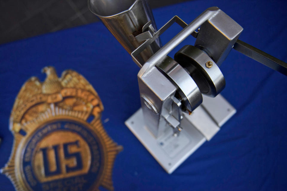 A seized pill press machine is displayed at a DEA news conference in Los Angeles in 2021. (Patrick T. Fallon  / AFP via Getty Images)