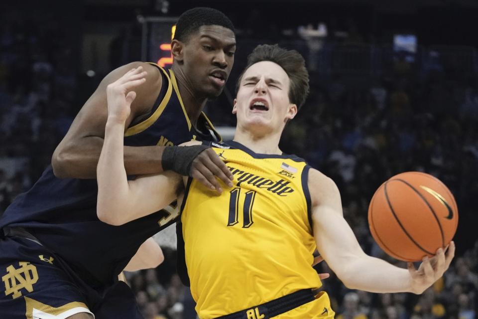 Notre Dame's Kebba Njie fouls Marquette's Tyler Kolek during the first half of an NCAA college basketball game Saturday, Dec. 9, 2023, in Milwaukee. (AP Photo/Morry Gash)