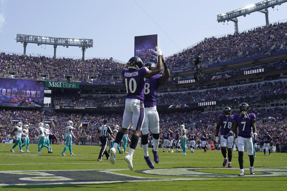 Baltimore Ravens quarterback Lamar Jackson (8) and wide receiver Demarcus Robinson (10) celebrate a touchdown during the first half of an NFL football game against the Miami Dolphins, Sunday, Sept. 18, 2022, in Baltimore. (AP Photo/Julio Cortez)