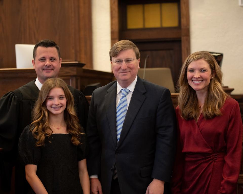 Gov. Tate Reeves, center, attending the investiture ceremony for 15th Circuit Judge Brad Touchstone, who is pictured with his wife, Janice Touchstone and daughter Ryleigh Touchstone, Friday, Jan. 27, 2023, at Lamar County, Miss., Courthouse.