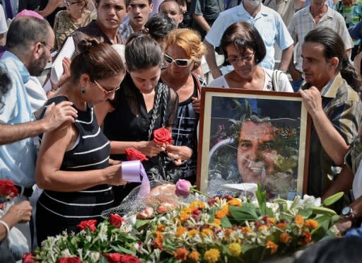 Ofelia Acevedo (L) widow of Cuban political activist Oswaldo Paya and their daughter Rosa Maria Paya (2nd-L) attend his funeral, on July 24, at Cristobal Colon cemetery in Havana. Cuban police arrested dozens of dissidents at the funeral, after his daughter's vow to seek justice over his sudden death in a road accident