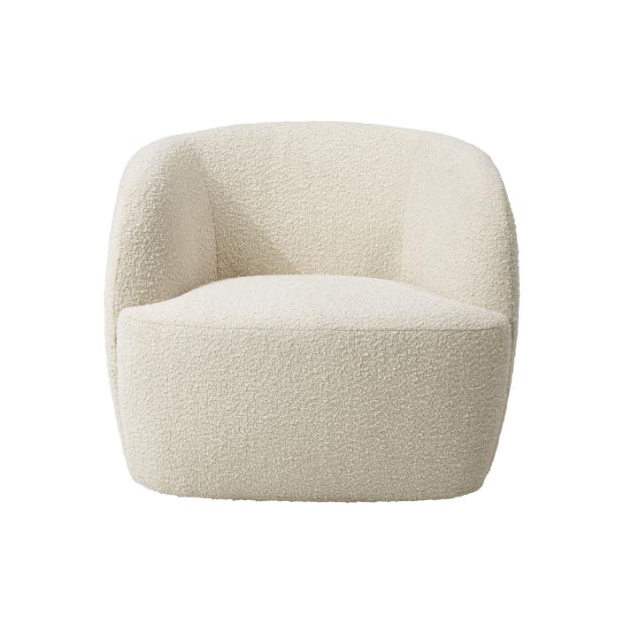 This undated photo shows CB2's Gwyneth side chair. Designer John McClain, whose studio is in Orlando, says one big trend he's seeing in fall décor is a range of deep, cozy textures like boucle and shearling. "(They're) are cropping up on more than just pillows these days – entire sofas, chairs and headboards are sporting luscious upholstery reminiscent of lambs, puppies and ponies." CB2 has several options, including the Gwyneth side chair, Logan sofa and Azalea chair. (CB2 via AP)
