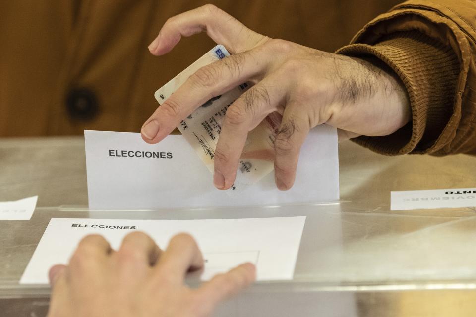 A man casts his vote for the general election in Pozuelo de Alarcon, Spain, Sunday, Nov.10, 2019. Spain holds its second national election this year after Socialist leader Pedro Sanchez failed to win support for his government in a fractured Parliament. (AP Photo/Bernat Armangue)