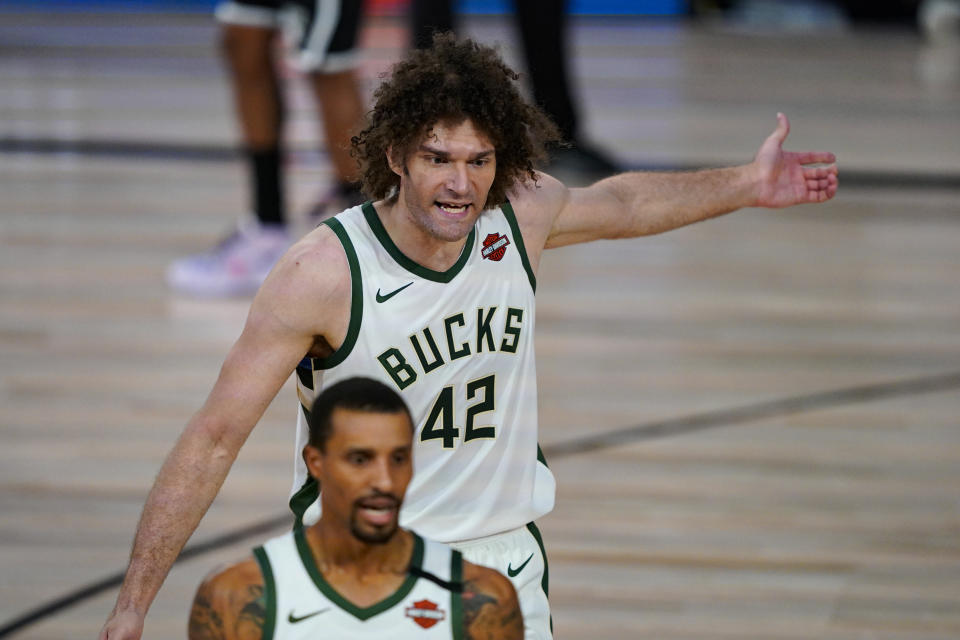 Milwaukee Bucks center Robin Lopez (42) reacts to a call during the first half of an NBA basketball game against the Brooklyn Nets Tuesday, Aug. 4, 2020 in Lake Buena Vista, Fla. (AP Photo/Ashley Landis)