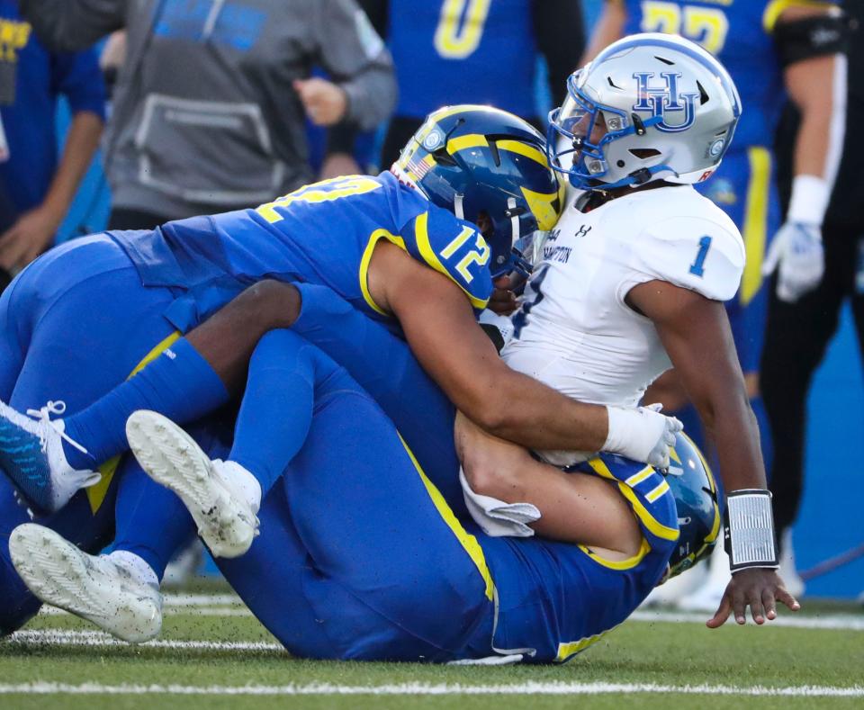 Delaware's Chase McGowan (12) and Liam Trainer sack Hampton's Christopher Zellous in the first quarter of the Blue Hens' 35-3 win at Delaware Stadium, Saturday, Sept. 24, 2022.