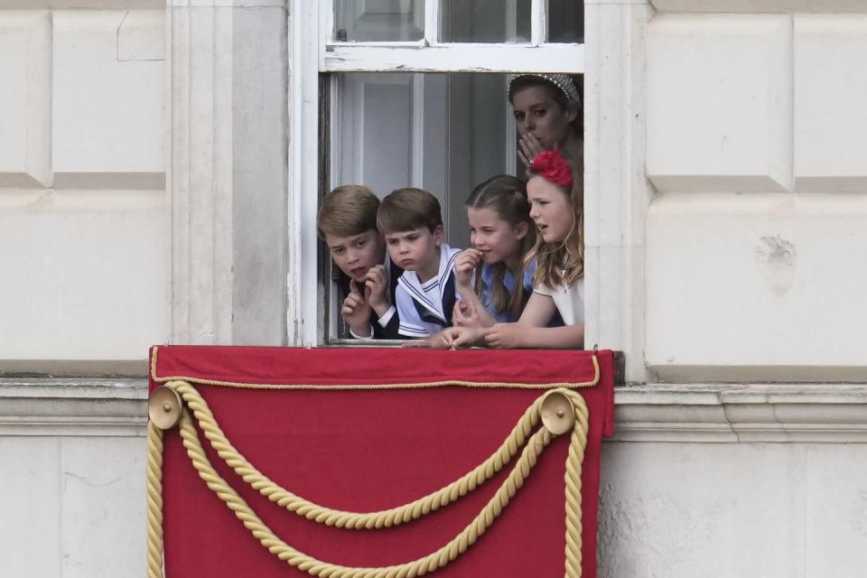 <p>Prince George, Princess Charlotte, Prince Louis, and their cousin <a href="https://www.townandcountrymag.com/society/tradition/a15158722/mia-tindall-facts/" rel="nofollow noopener" target="_blank" data-ylk="slk:Mia Tindall" class="link ">Mia Tindall</a> leaned out the window to watch the parade. Princess Beatrice is pictured in the back.</p>