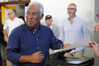 Portuguese Prime Minister and Socialist Party leader Antonio Costa picks up his ballot paper to vote at a poll station in Lisbon Sunday, Oct. 6, 2019. Portugal is holding a general election Sunday in which voters will choose members of the next Portuguese parliament. (AP Photo/Armando Franca)