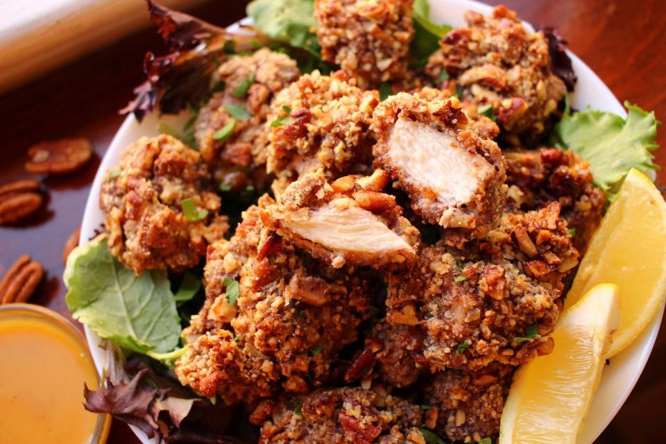 <p>Pecans and <a href="https://www.delish.com/chicken-breast-recipes/" rel="nofollow noopener" target="_blank" data-ylk="slk:chicken" class="link ">chicken</a> are an underrated pair: A quick dredge, then coated in crushed pecans, and baked for 15 minutes, this easy dish is perfect for dinner or a satisfying, snackable appetizer.</p><p>Get the <strong><a href="https://www.delish.com/cooking/recipe-ideas/a34132404/butter-pecan-chicken-bites-recipe/" rel="nofollow noopener" target="_blank" data-ylk="slk:Butter Pecan Chicken Bites recipe" class="link ">Butter Pecan Chicken Bites recipe</a></strong>.</p>