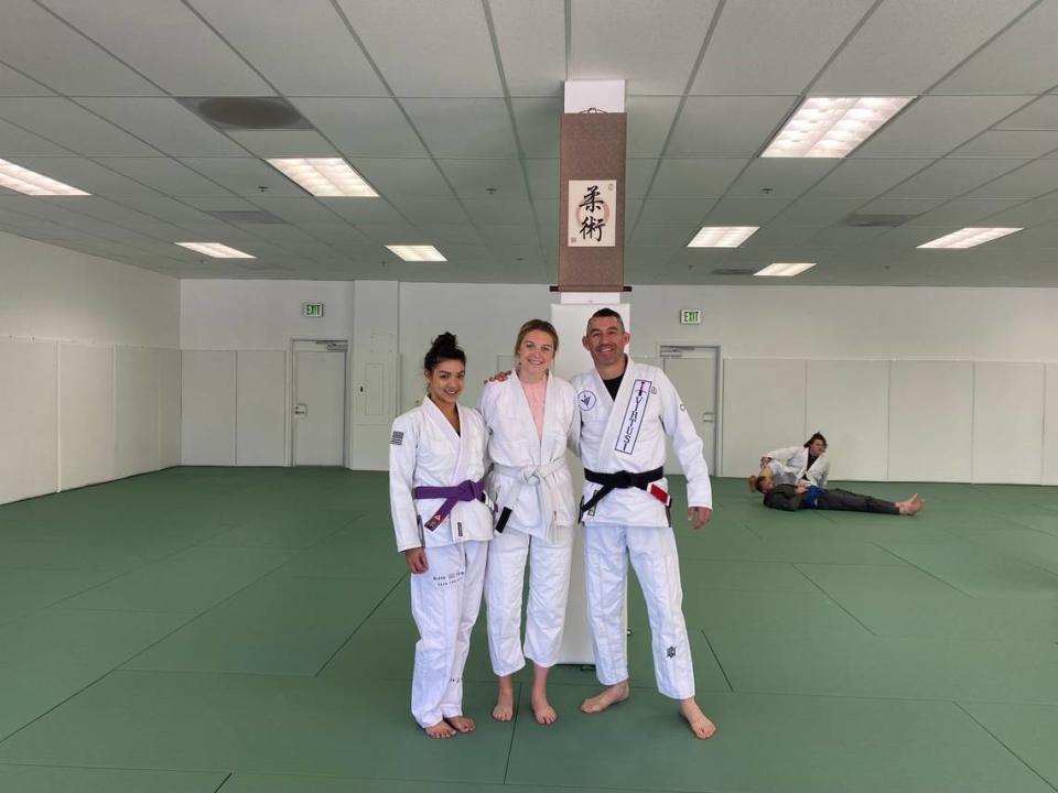 Retired Sergeants Melanie Franco and Eric Franco pose for a picture with San Luis Obispo Tribune Reporter, Lucy Peterson, at the new Virtus Brazilian Jiu Jistsu academy. Melanie Franco taught reporter Lucy Peterson basic self-defense moves.