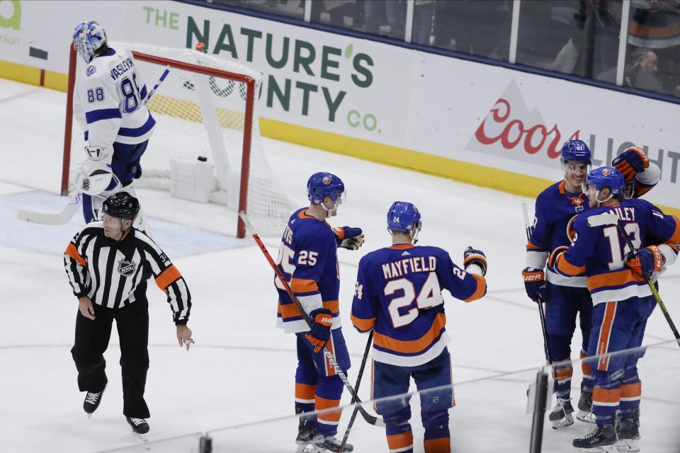 New York Islanders' Josh Bailey, right, celebrates with teammates as Tampa Bay Lightning goaltender Andrei Vasilevskiy (88) skates away after Bailey scored a goal during the third period of an NHL hockey game Friday, Nov. 1, 2019, in Uniondale, N.Y. The Islanders won 5-2. (AP Photo/Frank Franklin II)