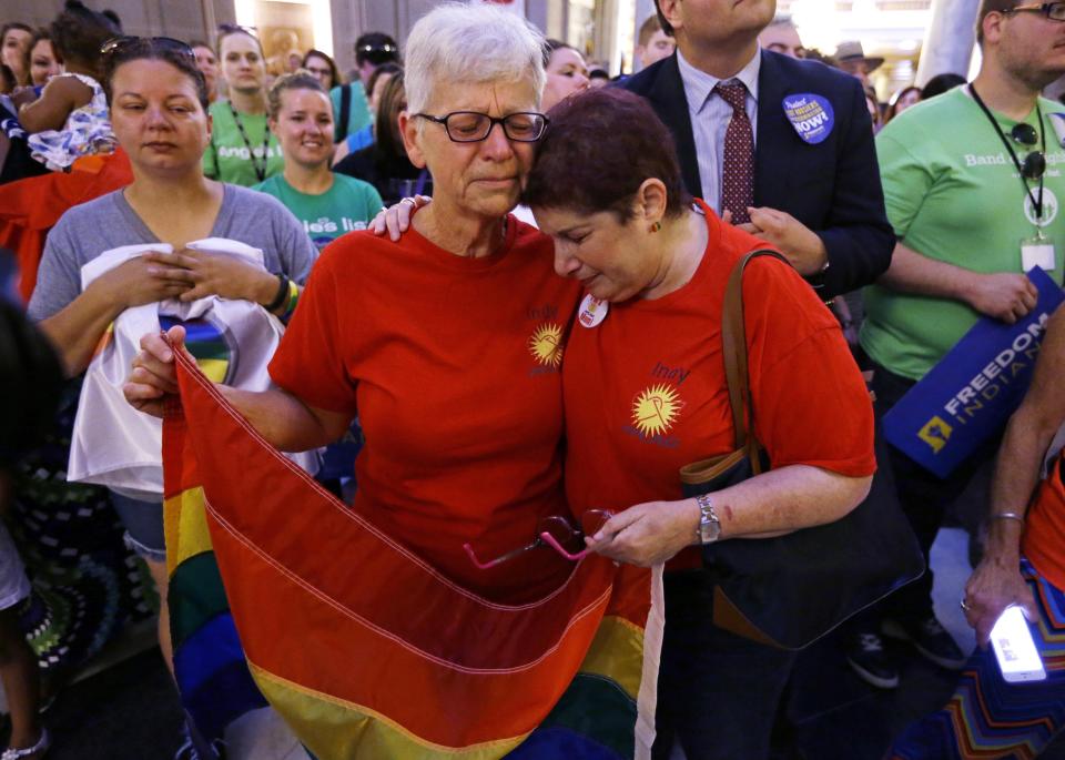 Betty Lynch, left, Carmel, Ind., and Annette Gross of Indianapolis, hug during a press conference in the Indiana Statehouse Rotunda in Indianapolis, Friday, June 26, 2015, after the Supreme Court declared that same-sex couples have a right to marry anywhere in the U.S. (AP Photo/Michael Conroy)