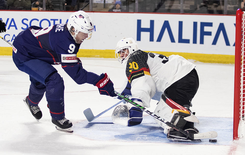 United States' Jackson Blake, left, scores against Germany's Nikita Quapp during second-period IIHF world junior hockey championships quarterfinal match action in Moncton, New Brunswick, Monday, Jan. 2, 2023. (Ron Ward/The Canadian Press via AP)