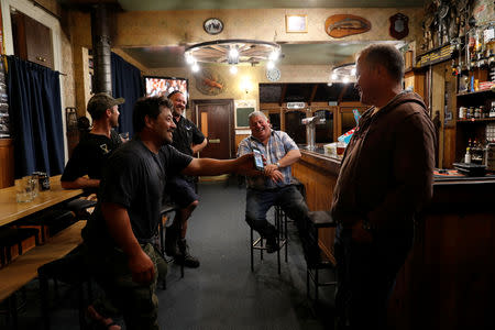 Noel Womersley smiles with friends in a pub after a hunter club meeting in Sefton outside Christchurch, New Zealand March 28, 2019. REUTERS/Jorge Silva