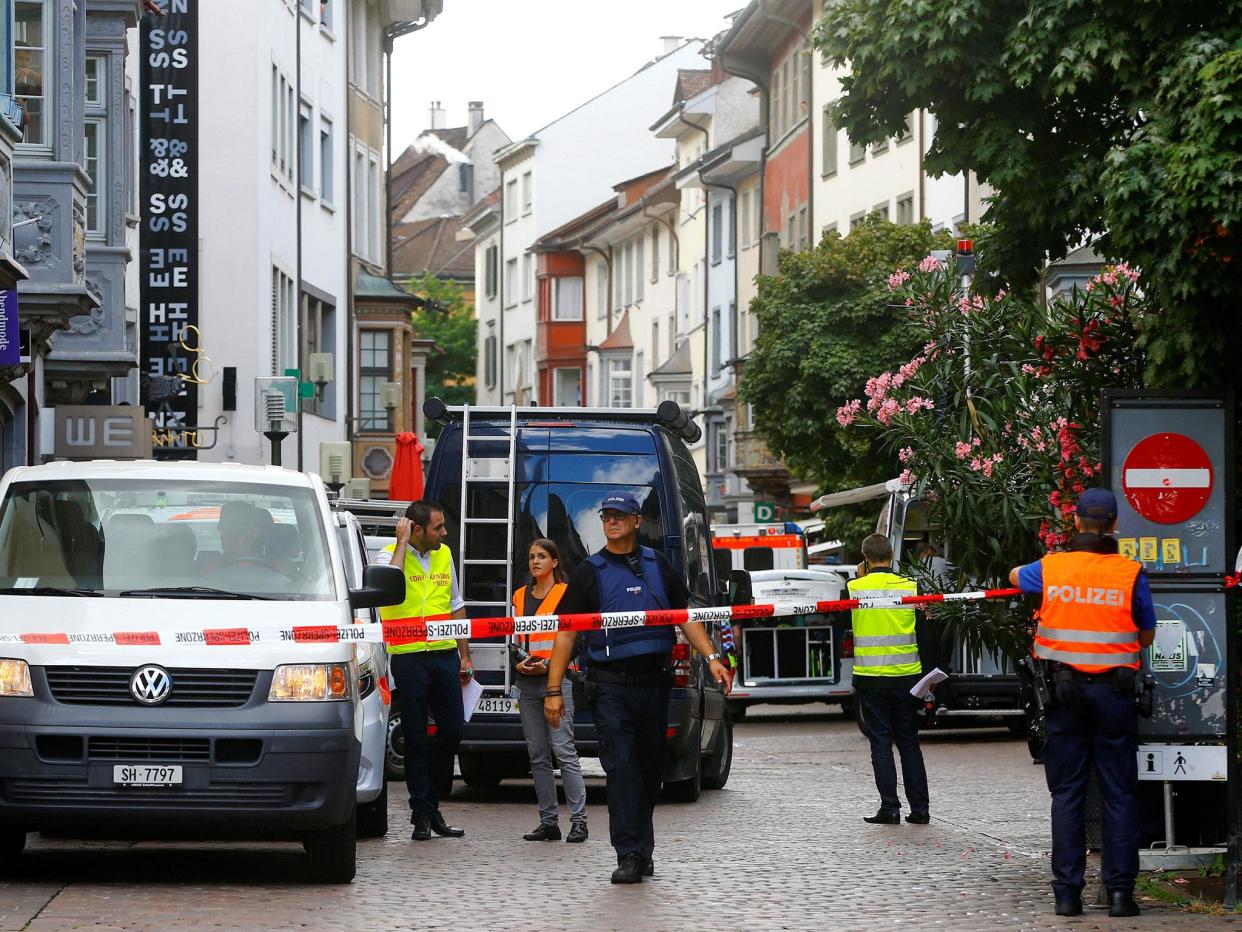 Swiss police officers stand at a crime scene in Schaffhausen, Switzerland: REUTERS/Arnd Wiegmann