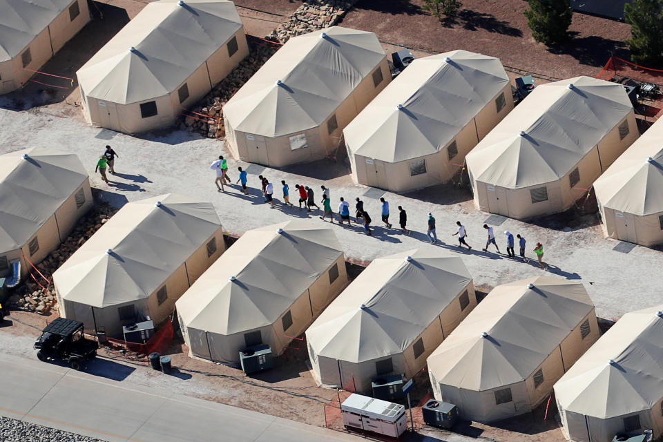 FILE PHOTO: Immigrant children now housed in a tent encampment under the new "zero tolerance" policy by the Trump administration are shown walking in single file at the facility near the Mexican border in Tornillo, Texas, U.S. June 19, 2018. REUTERS/Mike Blake/File Photo