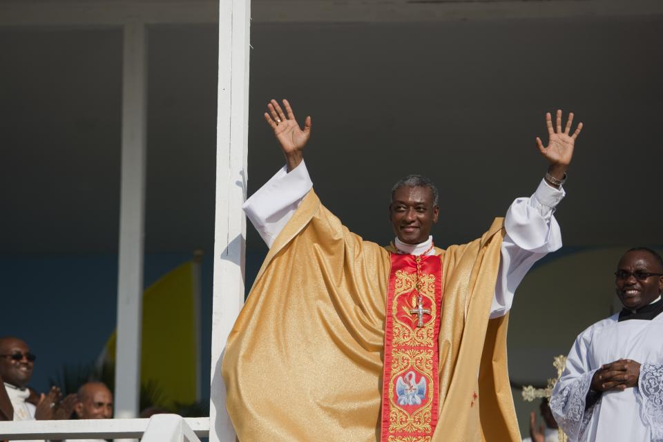 Newly-appointed Cardinal Chibly Langlois waves to parishioners during a Mass in Port-au-Prince, Haiti, Sunday March 9, 2014. Haiti's new Roman Catholic cardinal celebrated his first Mass, telling an audience of several thousand people there is a need to show compassion for others. (AP Photo/Dieu Nalio Chery)