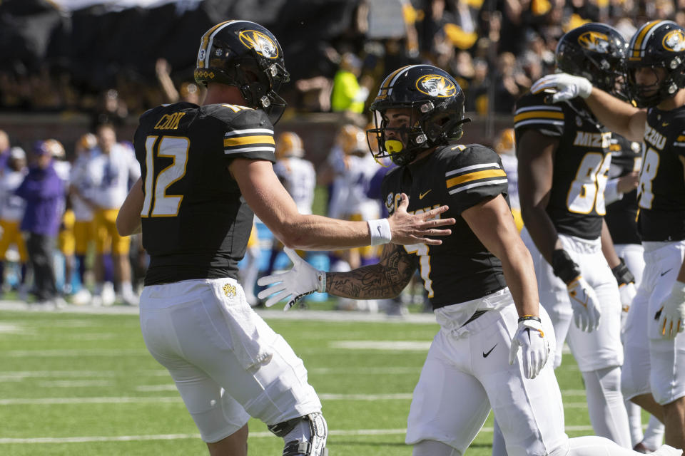 Missouri running back Cody Schrader, right, celebrates his touchdown with teammate Brady Cook, left, during the first quarter of an NCAA college football game against LSU Saturday, Oct. 7, 2023, in Columbia, Mo. (AP Photo/L.G. Patterson)