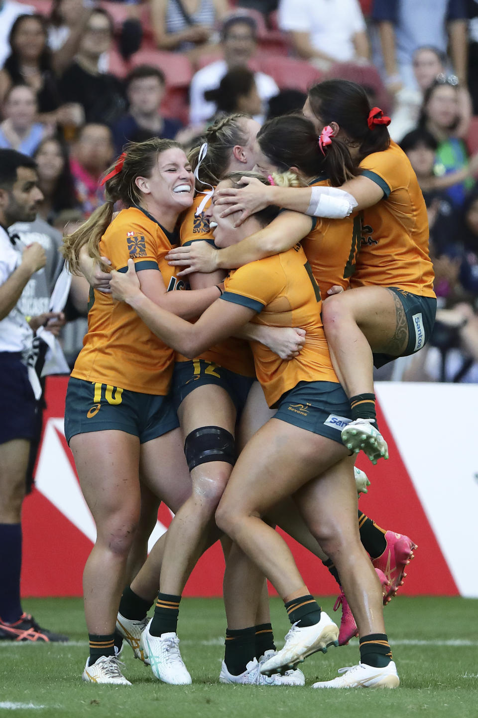 Australian players celebrate after defeating France during the women's HSBC World Rugby Sevens Series 2024 cup semifinals between Australia and France in Singapore, on Sunday, May 5, 2024. (AP Photo/Suhaimi Abdullah)