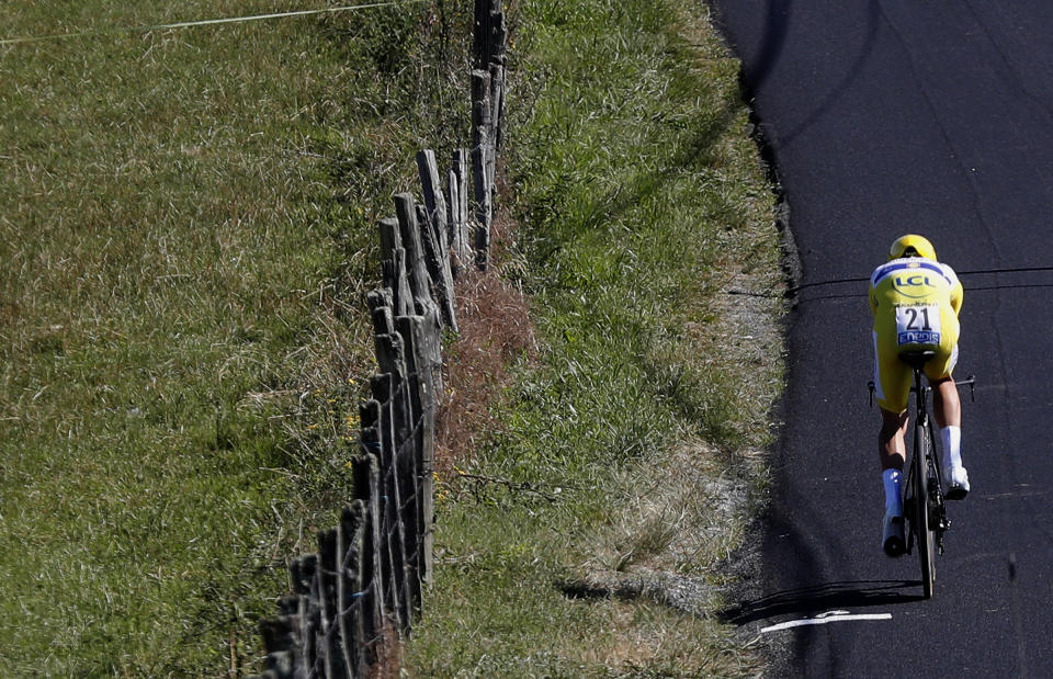 France's Julian Alaphilippe wearing the overall leader's yellow jersey rides during the thirteenth stage of the Tour de France cycling race, an individual time trial over 27.2 kilometers (16.9 miles) with start and finish in Pau, France, Friday, July 19, 2019. (AP Photo/Thibault Camus)