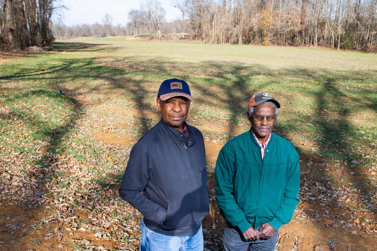 L.V. Jackson, a retired farmer, and his brother-in-law James Melvin Johnson Sr. pose for a portrait on a part of Johnson’s 40 acres of farmland in Jackson, Tenn., on Wednesday, Dec. 6, 2023. The land is currently empty but in season Johnson will grow soybeans. The men are applying for a piece of a $2.2 billion USDA Discrimination Financial Assistance Program, which aims to provide financial assistance to farmers, ranchers and forest landowners who experienced discrimination in USDA farm lending programs prior to 2021.