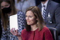 Supreme Court nominee Amy Coney Barrett holds up a notepad of paper during her confirmation hearing before the Senate Judiciary Committee on Capitol Hill in Washington, Tuesday, Oct. 13, 2020. (Brendan Smialowsi/Pool via AP)