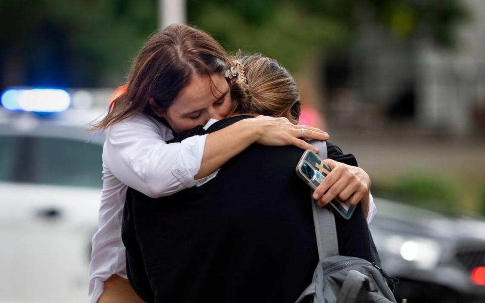 People console one another after being released from an August 28, 2023 lockdown at the University of North Carolina in Chapel Hill, N.C. following the shooting death of a professor. On Sept. 13, 2023 the campus went into lockdown for a second time after a man brandished a gun at a bagel shop in the student union.