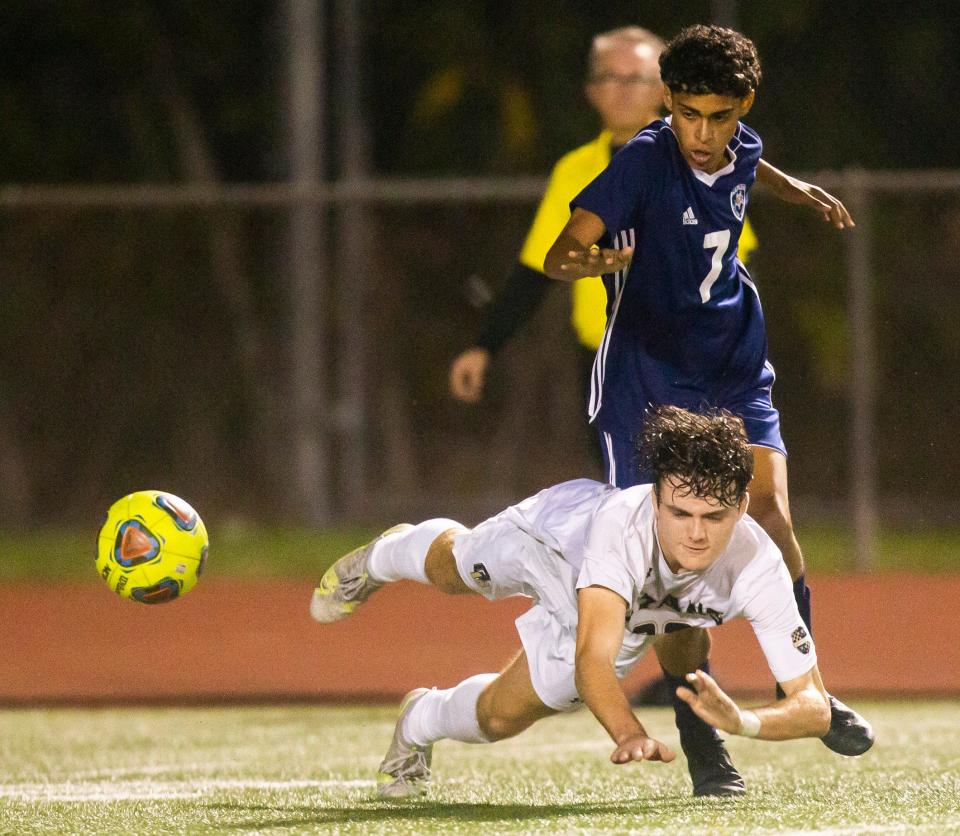 Golden Gate's Gregory Breston (22) falls during the boys soccer game between Golden Gate and Naples on Wednesday, Jan. 26, 2022 at Naples High School in Naples, Fla. 