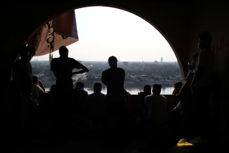 Iraqi demonstrators are seen inside the high-rise building, called by Iraqi the Turkish Restaurant Building, during anti-government protests in Baghdad